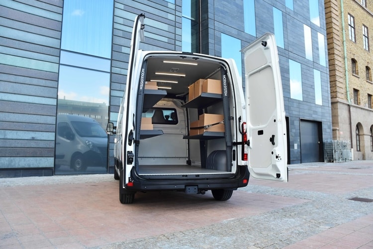 Van fitted out with modul-express van shelving holding delivery boxes